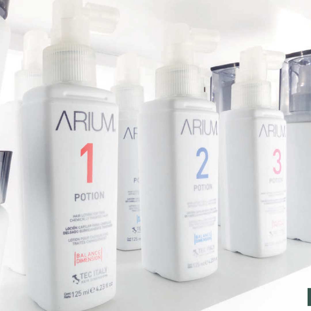 Tec Italy Arium hair loss products: 3 bright white bottles with spray nozzles at the top that allow them to spray onto the scalp for theraputic care.